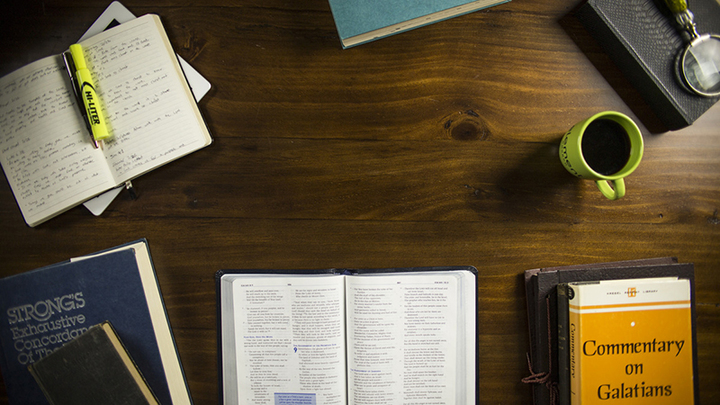 Medium books and bible on table